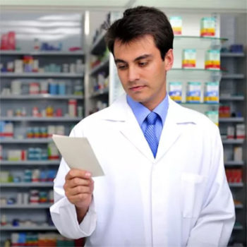 pharmacist reading a prescription